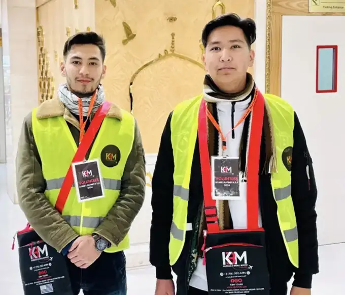 Two KBM volunteers in yellow vests